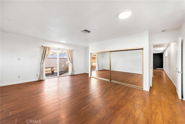 unfurnished bedroom with a closet and hardwood / wood-style floors