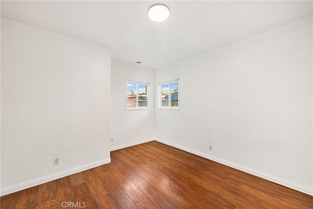 unfurnished room with hardwood / wood-style flooring