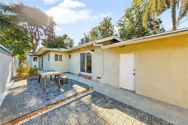 back of house with central AC unit and a patio