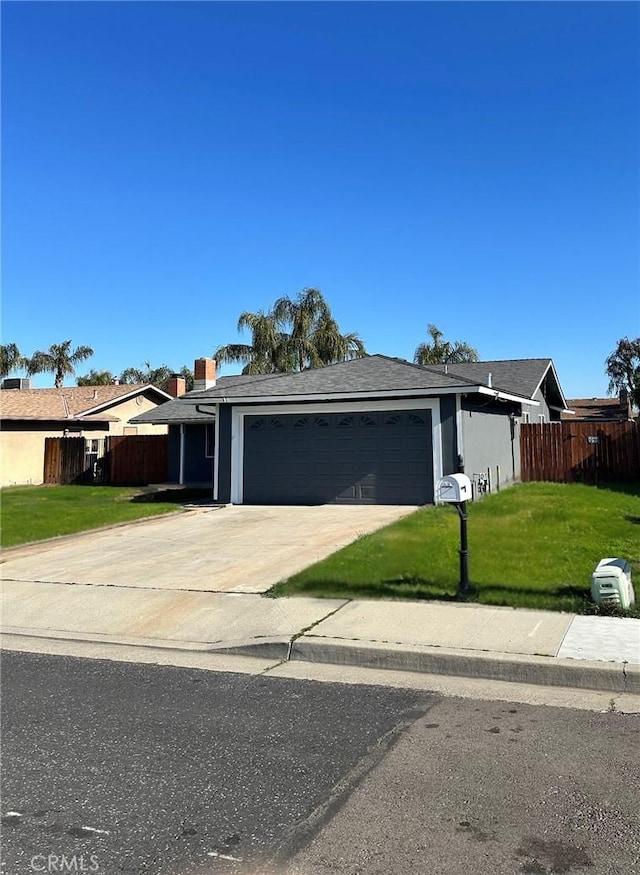 single story home with a garage and a front lawn