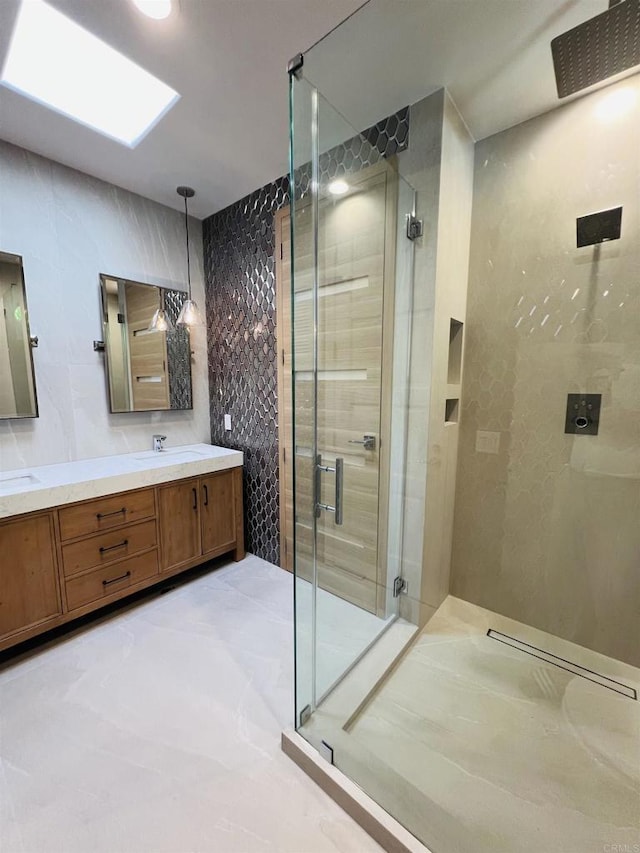 bathroom featuring an enclosed shower, vanity, and tile walls