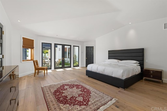 bedroom with french doors, lofted ceiling, light wood-type flooring, and access to outside