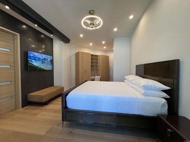 bedroom with wood finished floors and recessed lighting