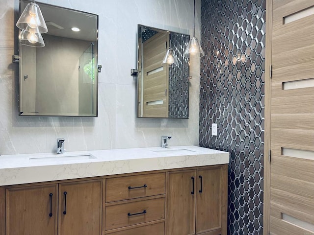 full bath featuring tile walls, decorative backsplash, and a sink