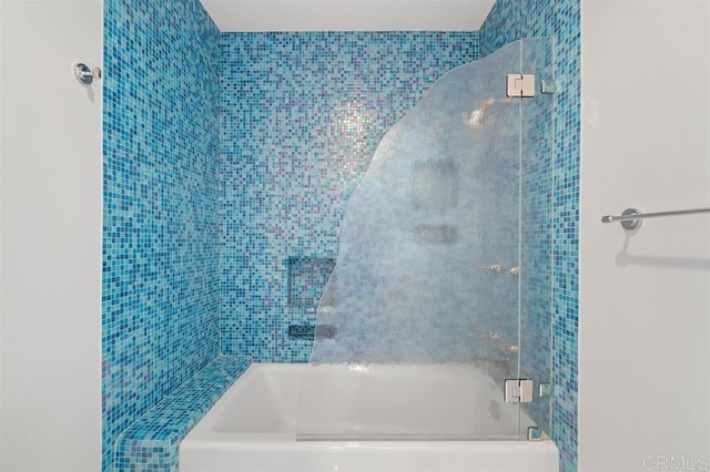 bathroom with shower / bath combination with glass door