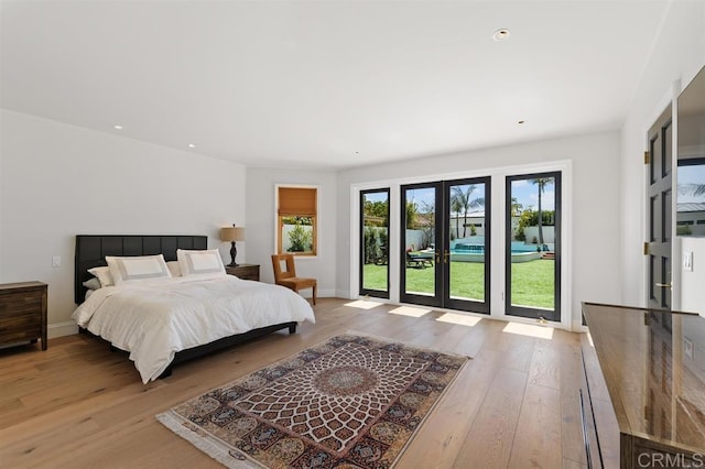 bedroom with baseboards, recessed lighting, access to outside, and light wood-style floors