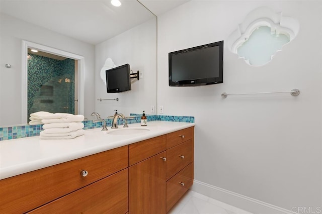 full bath featuring a shower with door, baseboards, and vanity