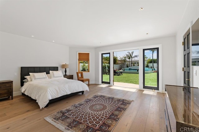 bedroom featuring baseboards, wood-type flooring, recessed lighting, and access to outside