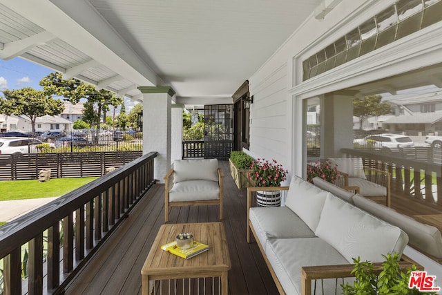 wooden terrace featuring covered porch