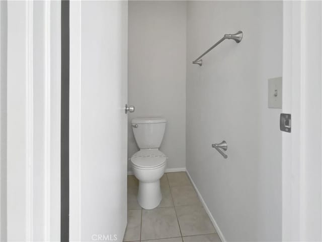 bathroom with tile patterned flooring and toilet