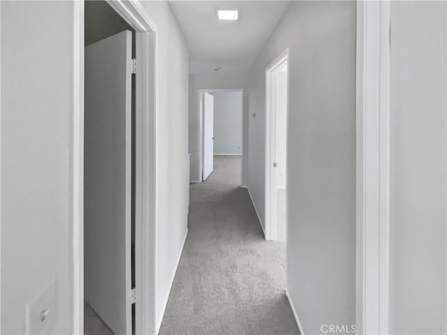 hallway with light colored carpet