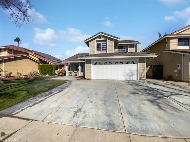 view of property featuring a garage and a front lawn