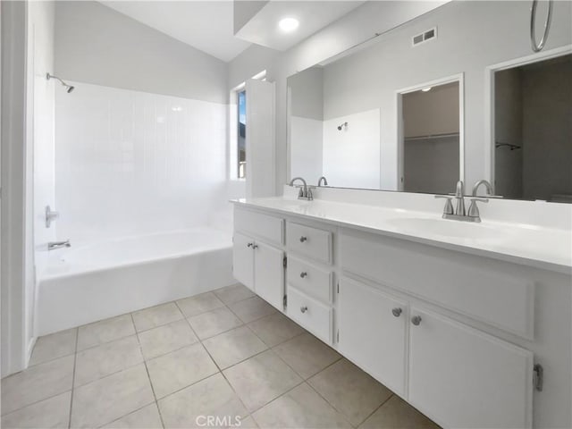 bathroom featuring vanity, tile patterned flooring, and shower / tub combination