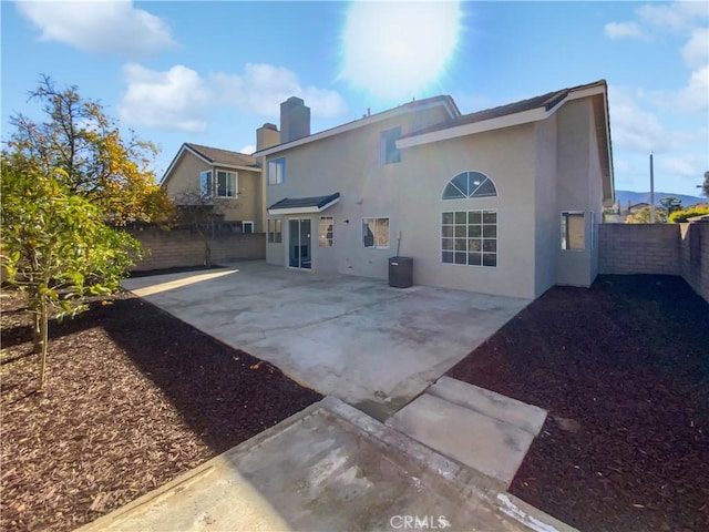 rear view of house featuring a patio