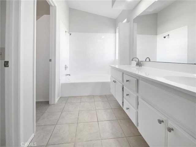 bathroom featuring tile patterned flooring, shower / tub combination, and vanity