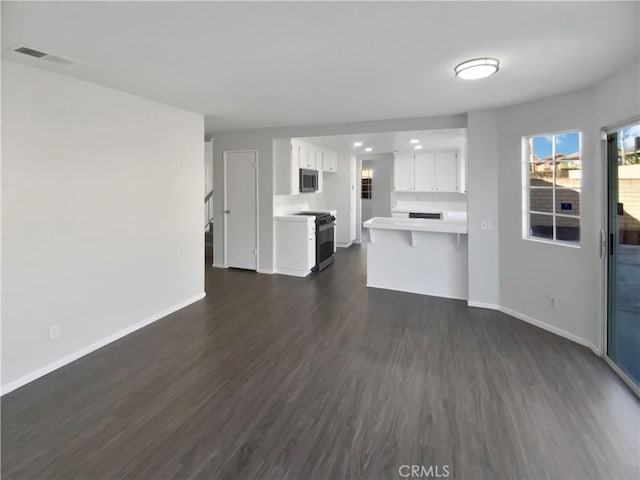 unfurnished living room featuring dark hardwood / wood-style floors