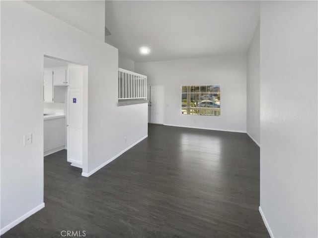 spare room featuring dark wood-type flooring