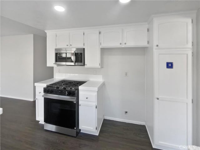 kitchen featuring white cabinetry, gas range, and dark hardwood / wood-style floors