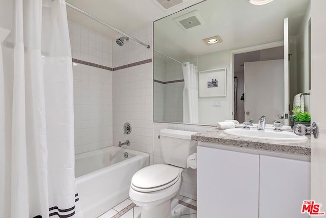 full bathroom with shower / tub combo, tile patterned flooring, vanity, and toilet