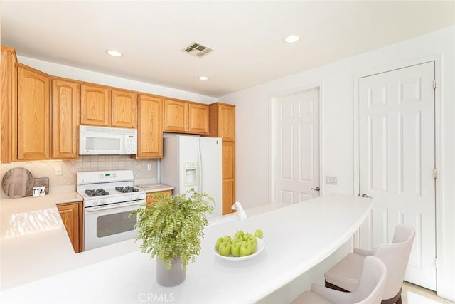1634 Scottsdale Rd, Beaumont, CA 92223 - kitchen featuring white appliances, light countertops, tasteful backsplash, recessed lighting, and a breakfast bar