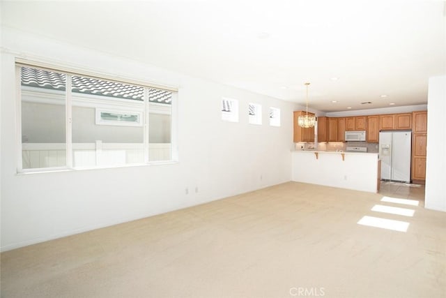 1634 Scottsdale Rd, Beaumont, CA 92223 - unfurnished living room with a chandelier and light colored carpet