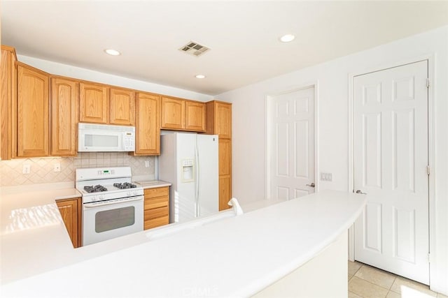 1634 Scottsdale Rd, Beaumont, CA 92223 - kitchen with white appliances, light countertops, light tile patterned flooring, decorative backsplash, and recessed lighting