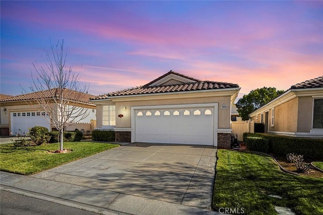 1634 Scottsdale Rd, Beaumont, CA 92223 - mediterranean / spanish house featuring a tile roof, stucco siding, driveway, and a garage