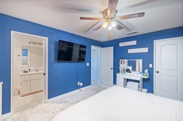 carpeted bedroom with ceiling fan and ensuite bathroom