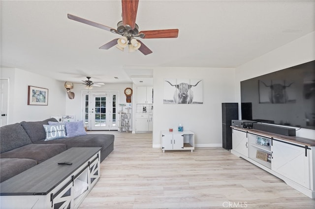 living room with french doors and light hardwood / wood-style floors