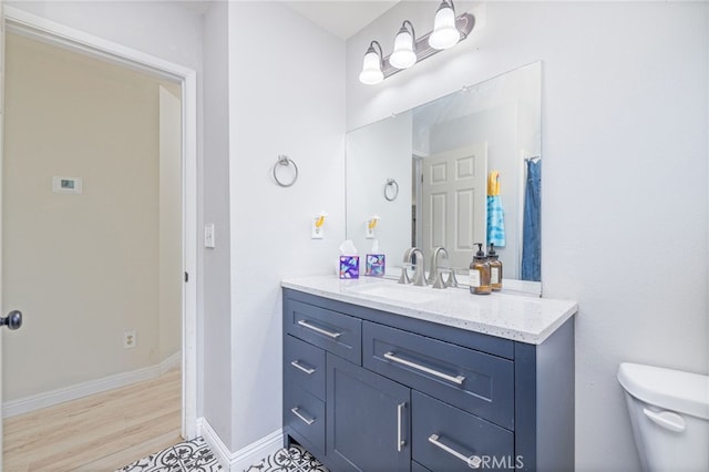 bathroom featuring toilet and vanity