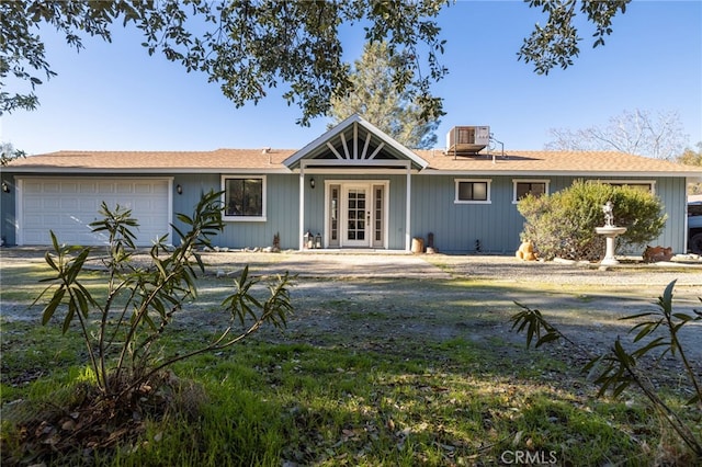 single story home with a garage and central AC