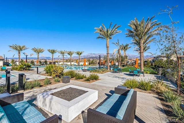 view of patio / terrace with a community pool and a mountain view