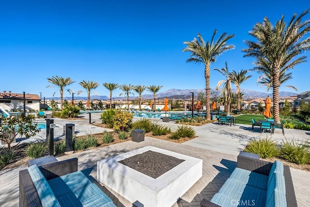 view of swimming pool featuring a patio area and a mountain view