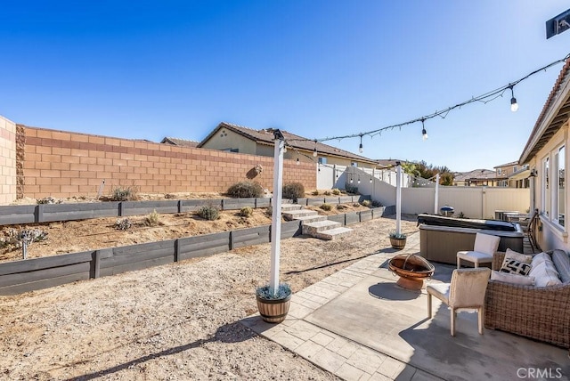 view of patio featuring a fire pit and a hot tub