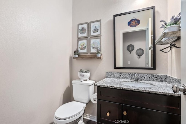 bathroom with toilet and vanity