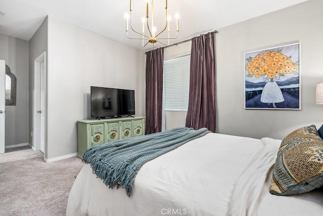 bedroom with a notable chandelier and light carpet