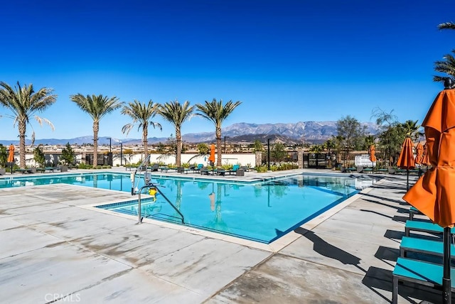 view of pool with a patio area and a mountain view