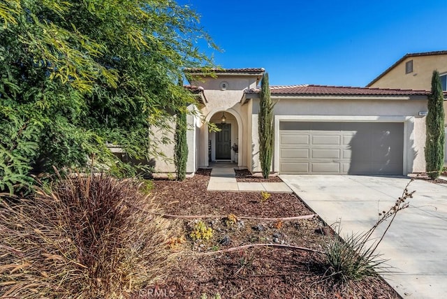 mediterranean / spanish home featuring a garage