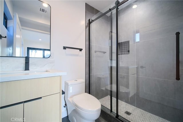 bathroom with vanity, toilet, and walk in shower