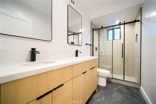 bathroom with an enclosed shower, vanity, and toilet