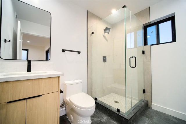 bathroom with walk in shower, vanity, and toilet