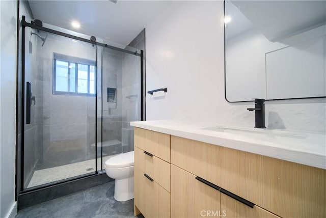 bathroom featuring walk in shower, vanity, and toilet