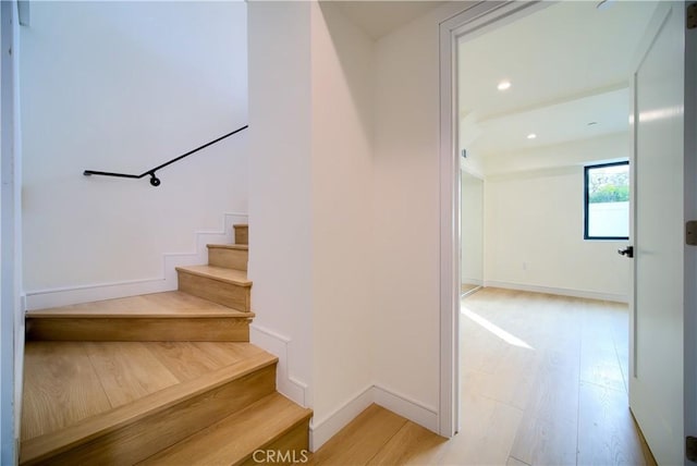 stairs with wood-type flooring