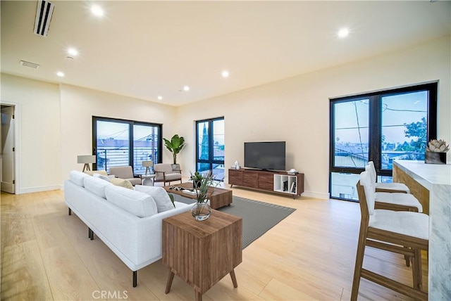 living room with light hardwood / wood-style flooring