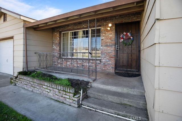 entrance to property featuring a porch and an attached garage