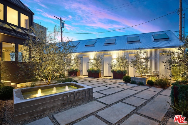 view of patio terrace at dusk