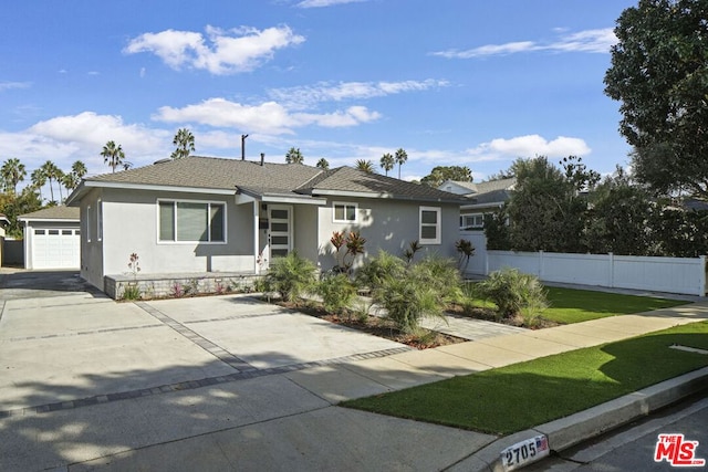 ranch-style house featuring a front lawn and a garage