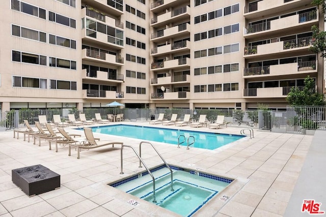 view of pool with a patio area and a community hot tub