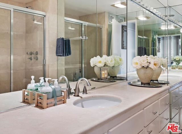 bathroom with an enclosed shower and vanity