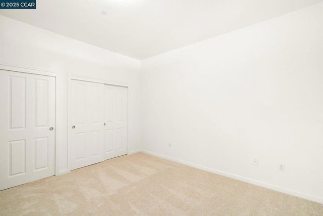 unfurnished bedroom with light carpet